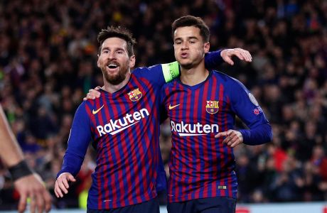 Barcelona forward Philippe Coutinho, right, celebrates with Barcelona forward Lionel Messi after scoring his side's second goal during the Champions League round of 16, 2nd leg, soccer match between FC Barcelona and Olympique Lyon at the Camp Nou stadium in Barcelona, Spain, Wednesday, March 13, 2019. (AP Photo/Manu Fernandez)
