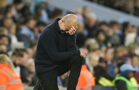 Manchester City's head coach Pep Guardiola reacts during the English Premier League soccer match between Manchester City and West Ham United at Etihad stadium in Manchester, England, Wednesday, May 3, 2023. (AP Photo/Dave Thompson)