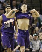 Phoenix Suns guard Devin Booker lifts his jersey after the team's NBA basketball game against the Boston Celtics, Friday, March 24, 2017, in Boston. Booker scored 70 points, but the Celtics won 130-120. Booker is just the sixth player in NBA history to score 70 or more points in a game. (AP Photo/Elise Amendola)