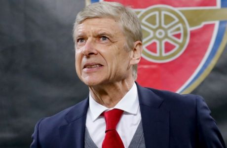 FILE - In this Thursday, March 8, 2018 file photo Arsenal's manager Arsene Wenger waits for the kick-off of the Europa League, round of 16 first-leg soccer match between AC Milan and Arsenal, at the Milan San Siro stadium, Italy. Arsenal manager Arsene Wenger says he will leave the English club at the end of the season after more than 21 years in charge. (AP Photo/Antonio Calanni, File)