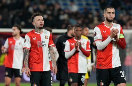 Feyenoord's David Hancko, right, and Feyenoord's Quilindschy Hartman, front left, are seen after the end of the Europa League play off, first leg soccer match between Feyenoord and Roma at De Kuip stadium in Rotterdam, Netherlands, Thursday, Feb. 15, 2024. The match ended 1-1. (AP Photo/Peter Dejong)