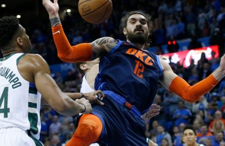 Oklahoma City Thunder center Steven Adams (12) after a basket in front of Milwaukee Bucks forward Giannis Antetokounmpo (34) in the first half of an NBA basketball game in Oklahoma City, Sunday, Jan. 27, 2019. (AP Photo/Sue Ogrocki)