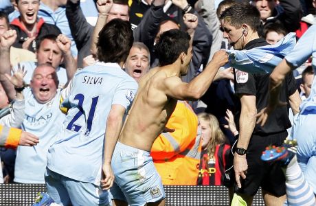 Manchester City's Sergio Aguero, center, celebrates after scoring against Queens Park Rangers during their English Premier League soccer match at the Etihad Stadium, Manchester, England, Sunday May 13, 2012. (AP Photo/Jon Super)