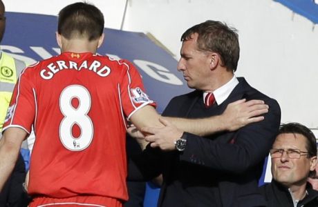 Liverpool's Steven Gerrard goes off the pitch as he is substituted, by Liverpool's head coach Brendan Rodgers, right, who shakes his hand during their English Premier League soccer match between Chelsea and Liverpool at Stamford Bridge stadium in London, Sunday, May 10,  2015. (AP Photo/Matt Dunham)