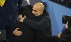 Manchester City's head coach Pep Guardiola, right, meets Arsenal's manager Mikel Arteta before the English FA Cup 4th round soccer match between Manchester City and Arsenal at the Etihad Stadium in Manchester, England, Friday, Jan. 27, 2023. (AP Photo/Dave Thompson)