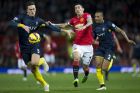 Manchester United's Angel Di Maria, centre right, fights for the ball against Southampton's Florin Gardos, left, as Nathaniel Clyne looks on during the English Premier League soccer match between Manchester United and Southampton at Old Trafford Stadium, Manchester, England, Sunday Jan. 11, 2015. (AP Photo/Jon Super)  