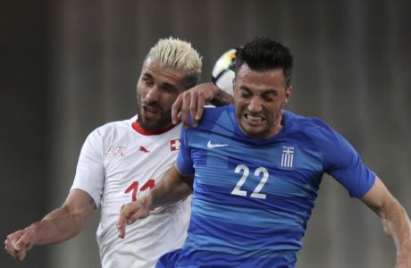 Switzerland's Valon Bahrami, left, duels for the ball with Greece's Andreas Samaris during an international friendly soccer match between Greece and Switzerland at the Olympic stadium in Athens, Friday, March 23, 2018. (AP Photo/Thanassis Stavrakis)