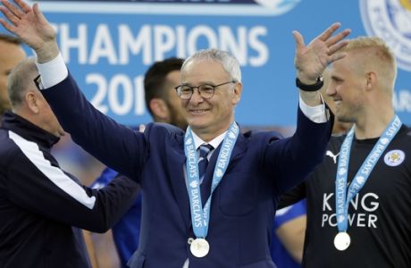 FILE - In this Saturday, May 7, 2016 file photo, Leicester's team manager Claudio Ranieri waves as Leicester City celebrate becoming the English Premier League soccer champions at King Power stadium in Leicester, England. Leicester is one of two newcomers in Europes elite club competition, the Champions League, this season, along with Rostov following its second-place finish in the Russian league. (AP Photo/Matt Dunham, File)