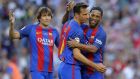 Former FC Barcelona player Frederic Dehu, center, celebrates after scoring with his teammate Ronaldinho, right, during the friendly soccer match between FC Barcelona legends and Manchester United legends at the Camp Nou stadium in Barcelona, Spain, Friday, June, 30, 2017. (AP Photo/Manu Fernandez)