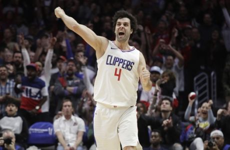 Los Angeles Clippers' Milos Teodosic celebrates his three-point basket during the second half of an NBA basketball game against the Toronto Raptors, Monday, Dec. 11, 2017, in Los Angeles. The Clippers won 96-91. (AP Photo/Jae C. Hong)