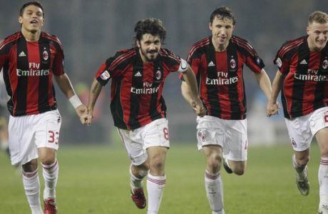 From left, AC Milan defender Thiago Silva, of Brazil, AC Milan midfielder Gennaro Gattuso , AC Milan midfielder Mark Van Bommel, of the Netherlands, and AC Milan midfielder Ignazio Abate celebrate at the end of a Serie A soccer match between Juventus and AC Milan at the Olympic stadium in Turin, Italy, Saturday, March 5, 2011. AC Milan won 1-0. (AP Photo/Luca Bruno)
