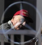 FILE - In this Friday, Feb. 20, 2015 file photo former Austrian Formula One driver Niki Lauda is pictured through a glass window, during the 2015 Formula One testing, at the Barcelona Catalunya racetrack in Montmelo, Spain. Three-time Formula One world champion Niki Lauda, who won two of his titles after a horrific crash that left him with serious burns and went on to become a prominent figure in the aviation industry, has died. He was 70. (AP Photo/Manu Fernandez, File)