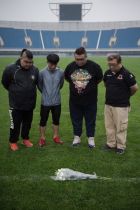 Chinese fans of Ivory Coast international and Beijing Enterprises club football player Cheick Tiote pay their respects and mark a minute of silence after laying a bouquet of flowers on the field of the National Olympic sport centre stadium in Beijing on June 6, 2017.
Tiote "suddenly fainted" at training and died later in hospital, his Chinese club said on June 6, as tributes flooded in for the player. / AFP PHOTO / NICOLAS ASFOURI
