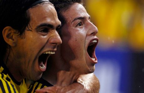 FILE- In this Sept. 6, 2013, file photo, Colombia's James Rodriguez, right, celebrates with Radamel Falcao Garcia after scoring at a 2014 World Cup qualifying soccer match against Ecuador in Barranquilla, Colombia. The "Coffee Growers" ripped through qualification, hammering Uruguay 4-0 on their way to earning 30 points from 16 matches. Falcao sealed qualification with two late goals against Chile, coming from behind for a 3-3 home draw. (AP Photo/Fernando Vergara, File)