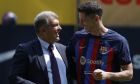 Polish forward Robert Lewandowski, right, and FC Barcelona president Joan Laporta react, during the official presentation after signing for FC Barcelona, in Barcelona, Spain, Friday, Aug. 5, 2022. (AP Photo/Joan Monfort)