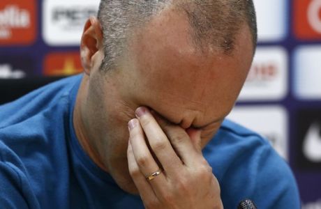 F.C. Barcelona player Andres Iniesta reacts during a news conference announcing he is leaving the club, in Barcelona, Spain, Friday, April. 27, 2018. Andres Iniesta says that he will leave Barcelona this summer after 16 trophy-packed seasons with the Spanish club. Iniesta, who turns 34 on May 11, says Friday "this season is the last." (AP Photo/Manu Fernandez)