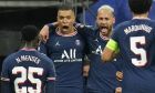 PSG's Kylian Mbappe, center left, celebrates with PSG's Neymar, center right, after Mbappe scored his side's first goal during the Champions League, round of 16, second leg soccer match between Real Madrid and Paris Saint-Germain at the Santiago Bernabeu stadium in Madrid, Spain, Wednesday, March 9, 2022. (AP Photo/Manu Fernandez)