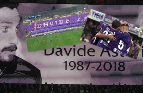 An image of Fiorentina captain Davide Astori is projected on a giant screen prior to the Champions League, round of 16, second-leg soccer match between Juventus and Tottenham Hotspur, at the Wembley Stadium in London, Wednesday, March 7, 2018. Fiorentina captain Davide Astori was found dead in his hotel room on Sunday at the age of 31 after a suspected cardiac arrest before an Italian league match. (AP Photo/Kirsty Wigglesworth)