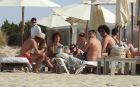EXCLUSIVE: Manchester United flop Marouane Fellaini puffs on a giant cigar - just days after Belgium were dumped out of Euro 2016 by Wales. The Belgian star, 28, was spotted relaxing on holiday in Ibiza with twin brother Mansour. An onlooker said: He didnt look like he had a care in the world. The group enjoyed drinks in the sunshine yesterday (July 4) surrounded by bikini-clad girls. Fellaini - in sunglasses and a hat - was seen knocking back what appeared to be cocktails and posing for photos with a fan. Pre-tournament favourites Belgium were knocked out of the competition after losing to Wales 3-1 on July 1. Fellaini has struggled to meet expectations at Old Trafford since signing with the club in the summer of 2013. Pics taken July 4th.