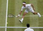 Switzerland's Roger Federer, top, returns the ball to Serbia's Novak Djokovic during the men's singles final match of the Wimbledon Tennis Championships in London, Sunday, July 14, 2019. (Will Oliver/Pool Photo via AP)