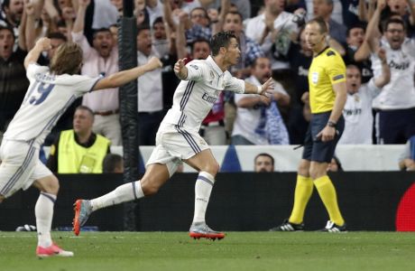 Real Madrid's Cristiano Ronaldo, 2nd left, celebrates after scoring his side's second goal during the Champions League quarterfinal second leg soccer match between Real Madrid and Bayern Munich at Santiago Bernabeu stadium in Madrid, Spain, Tuesday April 18, 2017. (AP Photo/Daniel Ochoa de Olza)