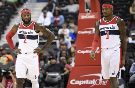 Washington Wizards guard John Wall (2) and guard Bradley Beal (3) stand on the court during the first half of an NBA preseason basketball game against the New York Knicks, Monday, Oct. 1, 2018, in Washington. (AP Photo/Nick Wass)