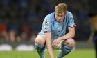 Manchester City's Kevin De Bruyne crouches on the pitch after getting injured during the Champions League final soccer match between Manchester City and Inter Milan at the Ataturk Olympic Stadium in Istanbul, Turkey, Saturday, June 10, 2023. (AP Photo/Francisco Seco)