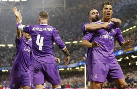 Real Madrid's Cristiano Ronaldo, right, celebrates after scoring the opening goal during the Champions League final soccer match between Juventus and Real Madrid at the Millennium stadium in Cardiff, Wales Saturday June 3, 2017. (AP Photo/Frank Augstein)