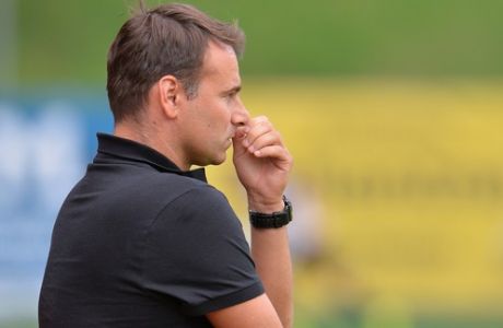 Maccabi's   coach Aleksandar Stanojevic whipes his nose  during the  friendly soccer match between Israel's  Maccabi Haifa and german club SC Paderborn in  Leogang, Austrian province of Salzburg, on Saturday, July 26. 2014.  On Wednesday, about 20 protesters waving Palestinian flags and signs with anti-Israeli slogans ran onto the pitch during Maccabi's friendly against French side Lille in Bischofshofen, near Salzburg. Players and protesters clashed, and the game was abandoned. (AP Photo/Kerstin Joensson) 
