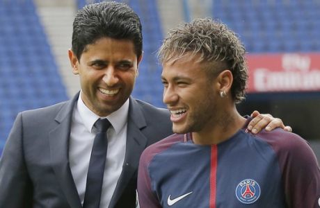 Brazilian soccer star Neymar walks away with the chairman of Paris Saint-Germain Nasser Al-Khelaifi, left, following a press conference in Paris Friday, Aug. 4, 2017. Neymar arrived in Paris on Friday the day after he became the most expensive player in soccer history when completing his blockbuster transfer to Paris Saint-Germain from Barcelona for 222 million euros ($262 million). (AP Photo/Michel Euler)
