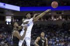 Duke forward RJ Barrett (5) passes to a teammate, away from Central Florida forward Chad Brown, left, during the first half of a second-round game in the NCAA men's college basketball tournament Sunday, March 24, 2019, in Columbia, S.C. Duke won 77-76. (AP Photo/Sean Rayford)