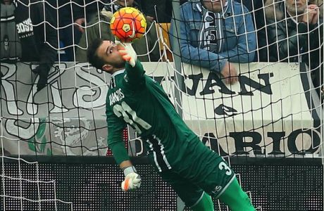 Udinese goalkeeper Orestis Karnezis, left, saves on Lazio's Sergej Milinkovic-Savic, during the Serie A soccer match between Udinese and Lazio at the Friuli Stadium in Udine, Italy, Sunday, Jan. 31, 2016. (AP Photo/Paolo Giovannini)