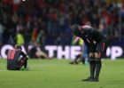 Arsenal's Alexandre Lacazette, right, covers his head with his shirt at the end of the Europa League semifinal, second leg soccer match between Atletico Madrid and Arsenal at the Metropolitano stadium in Madrid, Spain, Thursday, May 3, 2018. (AP Photo/Francisco Seco)