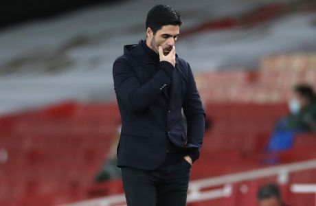 Arsenal's manager Mikel Arteta touches his face during an English Premier League soccer match between Arsenal and Southampton at the Emirates stadium in London, England, Wednesday, Dec. 16, 2020. (Peter Cziborra/Pool via AP)