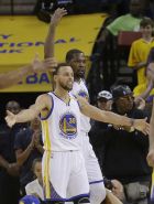 Golden State Warriors guard Stephen Curry (30) and forward Kevin Durant celebrate during the second half of Game 1 of a first-round NBA basketball playoff series against the Portland Trail Blazers in Oakland, Calif., Sunday, April 16, 2017. The Warriors won 121-109. (AP Photo/Jeff Chiu)