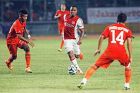 Ajax's Lerin Duarte, center, battles for the ball with Jakarta Soccer club Persija's Syahrizal, left, during their friendly soccer match at Gelora Bung Karno stadium in Jakarta, Indonesia, Sunday, May 11, 2014. Ajax won the match 3-0. (AP Photo/Achmad Ibrahim)