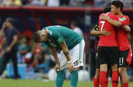 Germany's Niklas Suele, left, is dejected as South Korea's Son Heung-min, right, celebrates after the group F match between South Korea and Germany, at the 2018 soccer World Cup in the Kazan Arena in Kazan, Russia, Wednesday, June 27, 2018. South Korea won the match 2-0. (AP Photo/Frank Augstein)