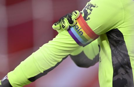 Leicester's goalkeeper Kasper Schmeichel adjusts his Rainbow Laces armband, part of a campaign to show support for all LGBT people, prior to the English Premier League soccer match between Sheffield United and Leicester City, at the Brammall Lane Stadium in Sheffield, England, Sunday, Dec. 6, 2020. (Laurence Griffiths, Pool via AP)