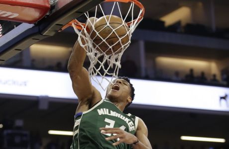 Milwaukee Bucks forward Giannis Antetokounmpo, left, goes up for a dunk as Sacramento Kings forward Skal Labissiere looks on during the first quarter of an NBA basketball game, Tuesday, Nov. 28, 2017, in Sacramento, Calif. (AP Photo/Rich Pedroncelli)
