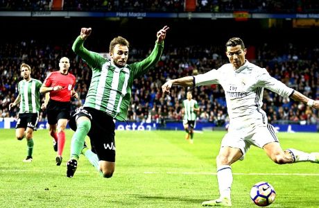 Real Madrid's Cristiano Ronaldo, right, challenges Real Betis' Alin Tosca during a Spanish La Liga soccer match between Real Madrid and Real Betis at the Santiago Bernabeu stadium in Madrid, Sunday, March 12, 2017. Ronaldo scored once in Real Madrid's 2-1 victory. (AP Photo/Francisco Seco)