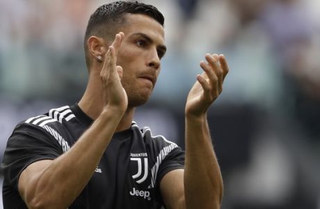 Juventus' Cristiano Ronaldo applauds his teams fans before the start of the Serie A soccer match between Juventus and Lazio at the Allianz Stadium in Turin, Italy, Saturday, Aug. 25, 2018. (AP Photo/Luca Bruno)