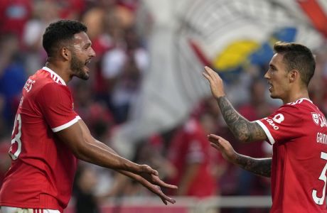 Benfica's Goncalo Ramos, left, celebrates with Benfica's Alex Grimaldo after scoring his side's second goal during the Champions League, third qualifying round, first leg soccer match between Benfica and Midtjylland at the Luz stadium in Lisbon, Portugal, Tuesday, Aug. 2, 2022. (AP Photo/Armando Franca)