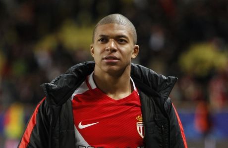 Monaco's Kylian Mbappe hold a soccer ball after the Champions League quarterfinal second leg soccer match between Monaco and Dortmund at the Louis II stadium in Monaco, Wednesday April 19, 2017. Monaco beat Borussia Dortmund 3-1 to reach the Champions League semifinals. (AP Photo/Claude Paris)