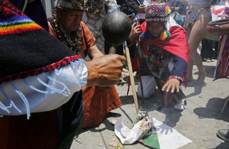 Shamans, witch doctors and dancers perform a rite in an attempt to bring good luck to Peru's national soccer team, a day prior to its play-off qualifying match for the 2018 Russian World Cup against New Zealand, outside the National Stadium in Lima, Peru, Wednesday, Nov. 14, 2017. (AP Photo/Rodrigo Abd)