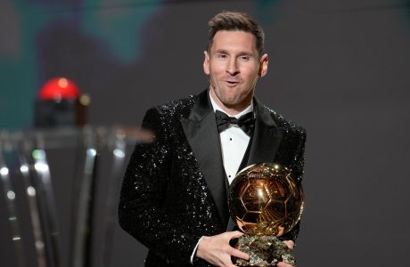 PSG player Lionel Messi reacts after winning the 2021 Ballon d'Or trophy during the 65th Ballon d'Or ceremony at Theatre du Chatelet, in Paris, Monday, Nov. 29, 2021. Messi won the Ballon d'Or for seventh time. (AP Photo/Christophe Ena)