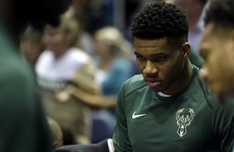 Milwaukee Bucks' Giannis Antetokounmpo is seen on the sidelines during a preseason NBA basketball game against the Indiana Pacers Wednesday, Oct. 4, 2017, in Milwaukee. (AP Photo/Aaron Gash)