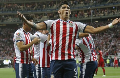 Chivas' Alan Pulido celebrates after his teammate Chivas' Orbelin Pineda scored against Toronto FC, during the CONCACAF Champions League final soccer match in Guadalajara, Mexico, Wednesday, April 25, 2018. (AP Photo/Eduardo Verdugo)