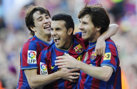 FC Barcelona's Pedro Rodriguez, center, reacts after scoring with his teammate Lionel Messi, from Argentina, right, and Bojan Krkic, left, against Valladolid during a Spanish La Liga soccer match at the Camp Nou stadium in Barcelona, Spain, Sunday, May 16, 2010. (AP Photo/Manu Fernandez)