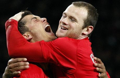 FILE - In this Tuesday March 4, 2008 file photo Manchester United's Cristiano Ronaldo, left, celebrates his goal with teammate Wayne Rooney against Lyon during their Champions League second round soccer match at Old Trafford Stadium, Manchester, England. Wayne Rooney now has the Derby County job on a permanent basis after Englands record goal-scorer retired from playing and received a contract through 2023 to manage the second tier team. The 35-year-old former Manchester United captain, who took temporary charge of Derby in November, is now focusing on his coaching career.  (AP Photo/Jon Super, File)