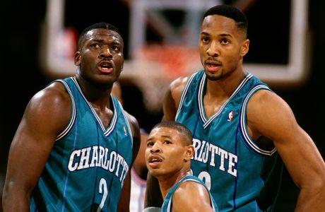 CHARLOTTE, NC - 1993:  (L-R) Larry Johnson #2, 'Mugsy' Bogues #1 and Alonzo Mourning #33 of the Charlotte Hornets take a break during an NBA game circa 1993 at The Charlotte Coliseum in Charlotte, North Carolina. NOTE TO USER: User expressly acknowledges  and agrees that, by downloading and or using this  photograph, User is consenting to the terms and conditions of the Getty Images License Agreement  (Photo by Andrew D. Bernstein/ NBAE via Getty Images)